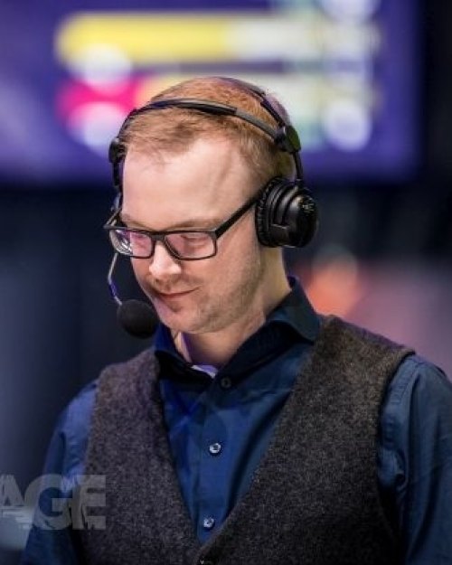 Tobias on stage as an esports commentator, wearing a headset